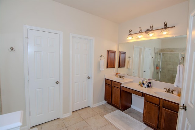 20018 Rene Creek Ct, Spring, TX 77388 - bathroom with tile patterned floors, a stall shower, double vanity, and baseboards