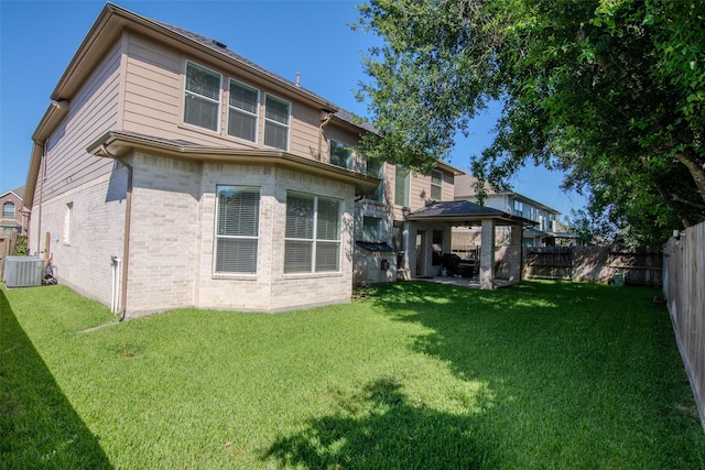 20018 Rene Creek Ct, Spring, TX 77388 - rear view of property featuring central AC unit, brick siding, and a gazebo