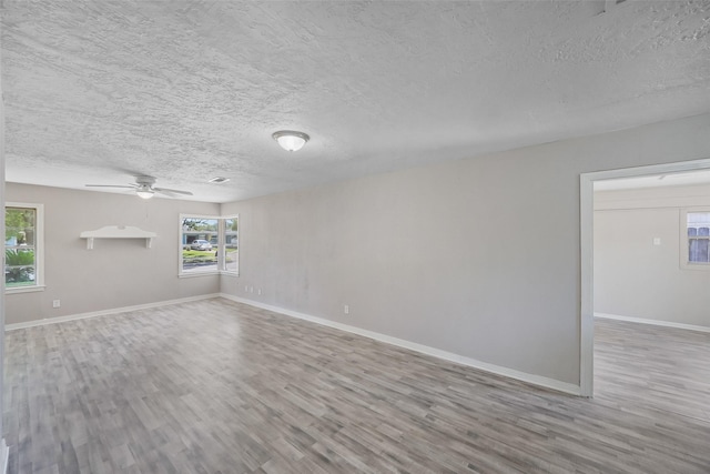 8527 Brower St, Houston, TX 77017 - unfurnished living room with wood finished floors, a textured ceiling, a ceiling fan, and baseboards