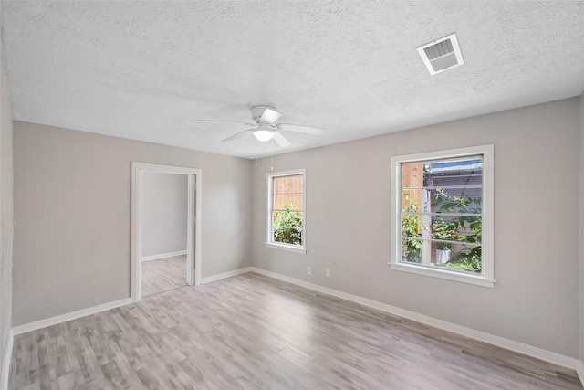 8527 Brower St, Houston, TX 77017 - spare room featuring wood finished floors, a textured ceiling, baseboards, and ceiling fan