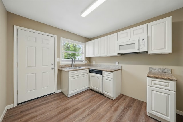 3615 Seabrook St, Houston, TX 77021 - kitchen featuring dishwasher, a sink, white microwave, light wood-style flooring, and white cabinets