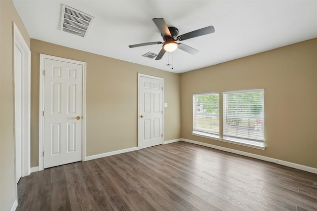 3615 Seabrook St, Houston, TX 77021 - unfurnished bedroom with dark wood-style floors, baseboards, and ceiling fan
