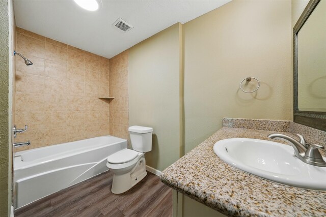 3615 Seabrook St, Houston, TX 77021 - full bathroom featuring a sink, wood finished floors, toilet, and bathing tub / shower combination
