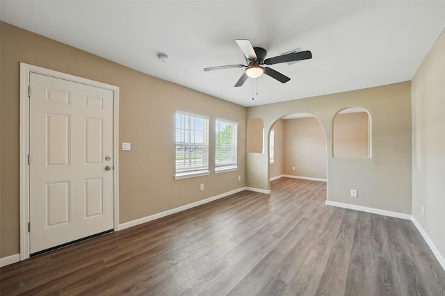 3615 Seabrook St, Houston, TX 77021 - unfurnished room featuring a ceiling fan, wood finished floors, baseboards, arched walkways, and a smoke detector