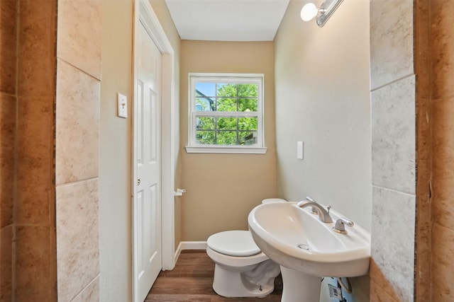 3615 Seabrook St, Houston, TX 77021 - half bath featuring toilet, wood finished floors, baseboards, and a sink