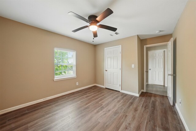 3615 Seabrook St, Houston, TX 77021 - unfurnished bedroom with wood finished floors, baseboards, and ceiling fan