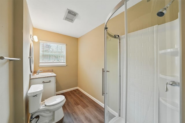 3615 Seabrook St, Houston, TX 77021 - bathroom featuring a shower stall, wood finished floors, toilet, baseboards, and vanity