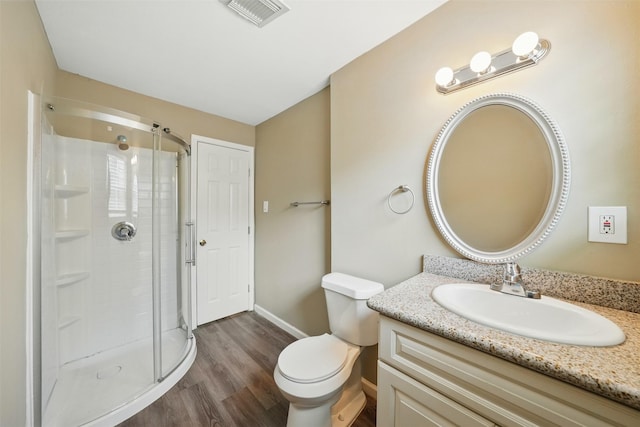 3615 Seabrook St, Houston, TX 77021 - bathroom with wood finished floors, a shower stall, toilet, baseboards, and vanity