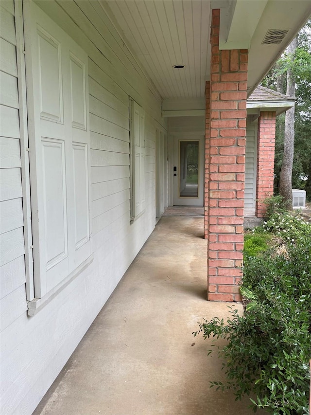 10611 Crystal Cove Dr, Magnolia, TX 77354 - view of exterior entry with a porch and central AC unit