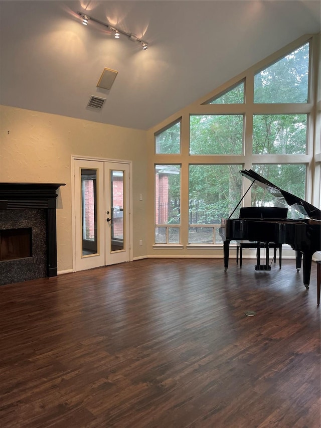 10611 Crystal Cove Dr, Magnolia, TX 77354 - living area with healthy amount of natural light, dark wood-style flooring, track lighting, french doors, and high vaulted ceiling