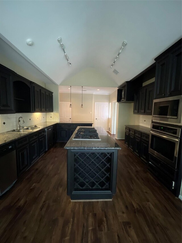 10611 Crystal Cove Dr, Magnolia, TX 77354 - kitchen with appliances with stainless steel finishes, a sink, vaulted ceiling, track lighting, and stone counters