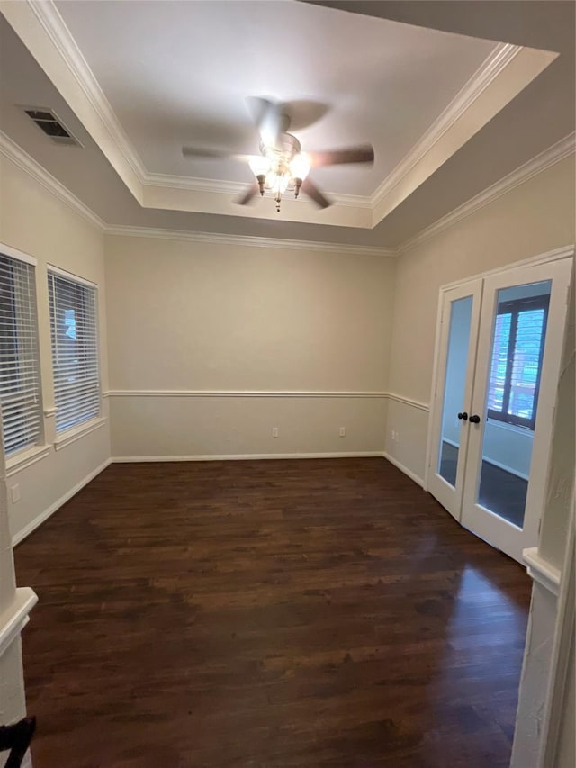 10611 Crystal Cove Dr, Magnolia, TX 77354 - spare room with a tray ceiling, french doors, dark wood-style floors, and crown molding