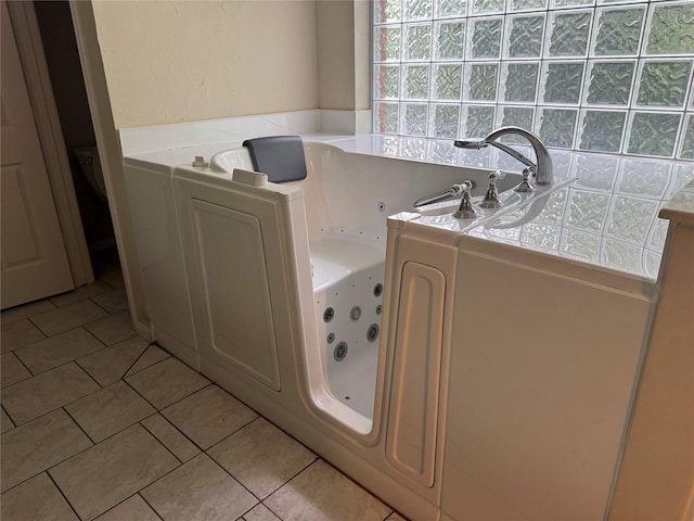 10611 Crystal Cove Dr, Magnolia, TX 77354 - full bathroom with tile patterned floors and a whirlpool tub