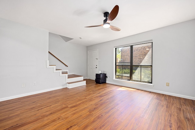 10328 Longmont Dr Unit 47/1, Houston, TX 77042 - unfurnished living room featuring ceiling fan, wood finished floors, and baseboards
