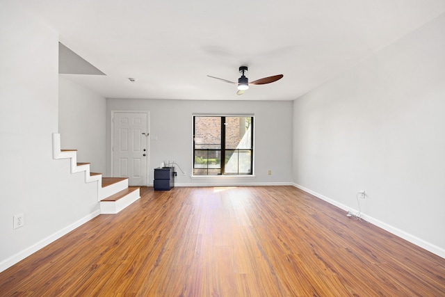 10328 Longmont Dr Unit 47/1, Houston, TX 77042 - unfurnished living room with baseboards, wood finished floors, and ceiling fan