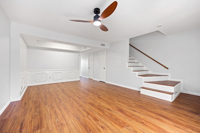 10328 Longmont Dr Unit 47/1, Houston, TX 77042 - unfurnished living room with a ceiling fan, stairs, wood finished floors, and baseboards