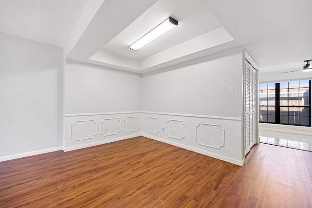 10328 Longmont Dr Unit 47/1, Houston, TX 77042 - unfurnished room featuring a raised ceiling, wood finished floors, and baseboards