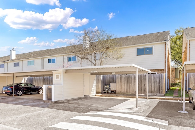 10328 Longmont Dr Unit 47/1, Houston, TX 77042 - back of house featuring fence and covered parking