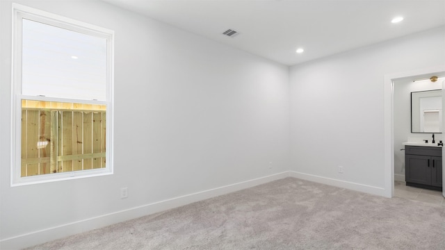 3603 Mount Pleasant St, Houston, TX 77021 - empty room with light carpet, a sink, baseboards, and recessed lighting