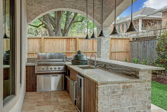 6206 Terwilliger Way, Houston, TX 77057 - view of patio / terrace featuring a grill, a sink, fence, an outdoor kitchen, and wine cooler