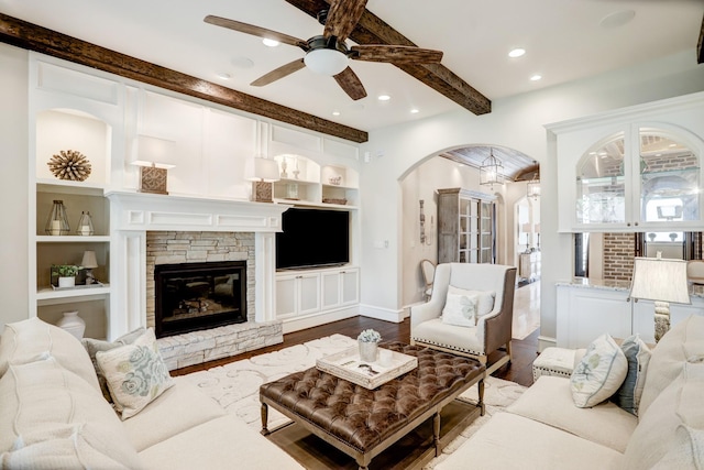 6206 Terwilliger Way, Houston, TX 77057 - living room with a ceiling fan, arched walkways, beamed ceiling, dark wood-type flooring, and built in shelves