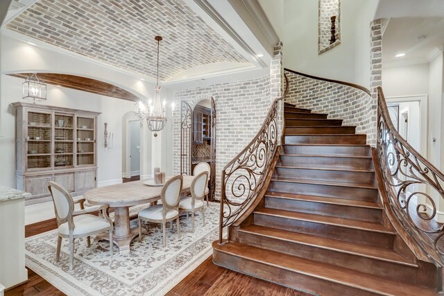 6206 Terwilliger Way, Houston, TX 77057 - dining area with arched walkways, brick ceiling, wood finished floors, stairs, and lofted ceiling