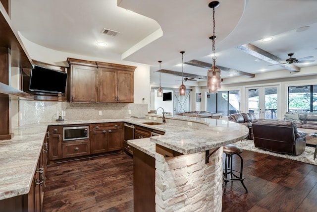 6206 Terwilliger Way, Houston, TX 77057 - kitchen featuring a sink, a peninsula, dark wood finished floors, stainless steel microwave, and open floor plan