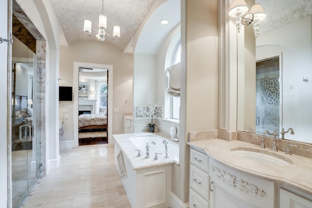 6206 Terwilliger Way, Houston, TX 77057 - full bath featuring ensuite bath, a fireplace, a shower stall, a chandelier, and a garden tub