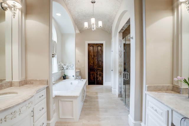 6206 Terwilliger Way, Houston, TX 77057 - bathroom featuring a bath, a shower stall, a chandelier, lofted ceiling, and two vanities