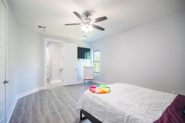 12422 Texas Army Trl, Cypress, TX 77429 - bedroom featuring wood finished floors, baseboards, and a ceiling fan
