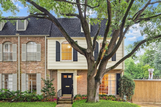 495 N Post Oak Ln, Houston, TX 77024 - view of front of home with a shingled roof, brick siding, entry steps, and fence