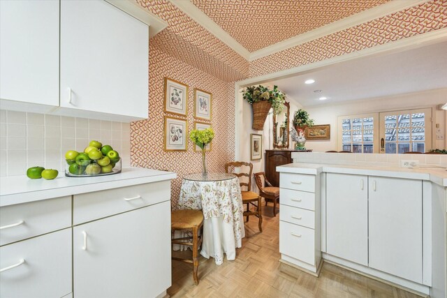 495 N Post Oak Ln, Houston, TX 77024 - kitchen featuring light countertops, wallpapered walls, white cabinetry, recessed lighting, and ornamental molding
