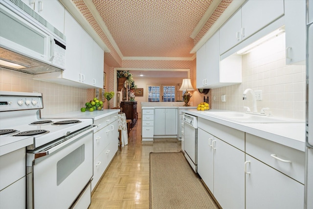 495 N Post Oak Ln, Houston, TX 77024 - kitchen with white appliances, backsplash, a sink, and light countertops