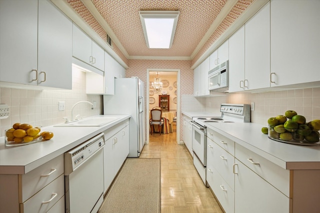 495 N Post Oak Ln, Houston, TX 77024 - kitchen with white appliances, a sink, backsplash, wallpapered walls, and crown molding