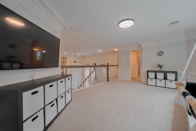 12438 Piping Rock Dr, Houston, TX 77077 - hallway featuring an upstairs landing, light colored carpet, a decorative wall, ornamental molding, and wainscoting