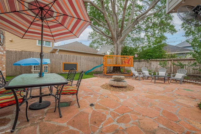 12438 Piping Rock Dr, Houston, TX 77077 - fenced backyard featuring a playground, a patio area, and outdoor dining space