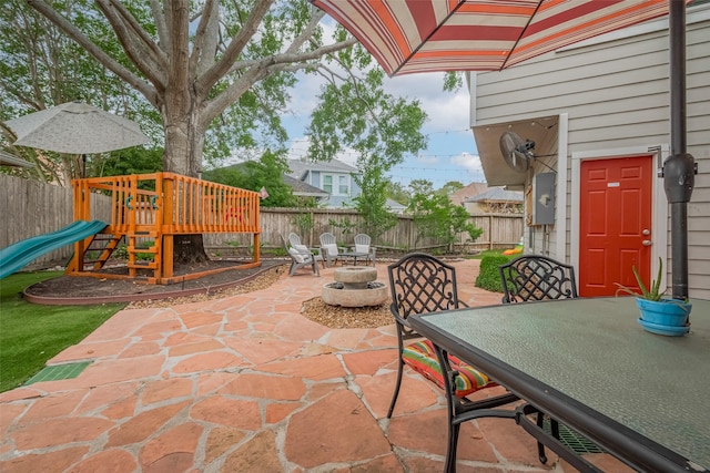 12438 Piping Rock Dr, Houston, TX 77077 - fenced backyard featuring a patio, a playground, and outdoor dining space