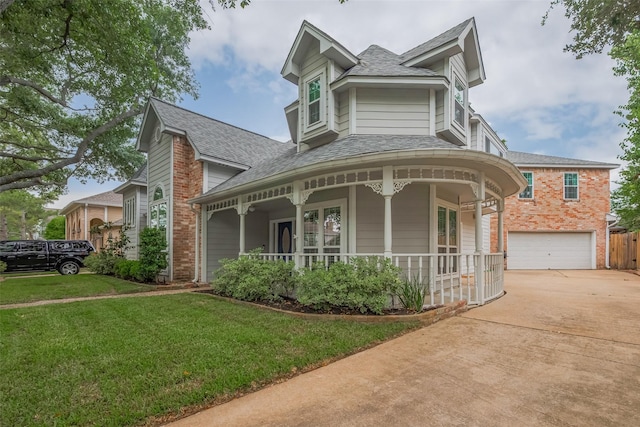 12438 Piping Rock Dr, Houston, TX 77077 - victorian-style house with covered porch, a shingled roof, a front yard, driveway, and a garage