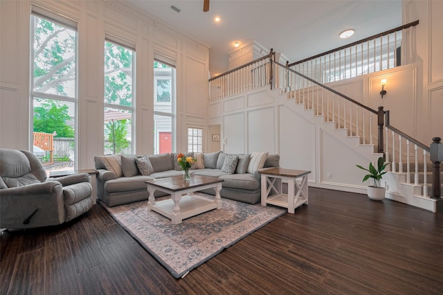 12438 Piping Rock Dr, Houston, TX 77077 - living area with a decorative wall, stairway, a high ceiling, and dark wood finished floors