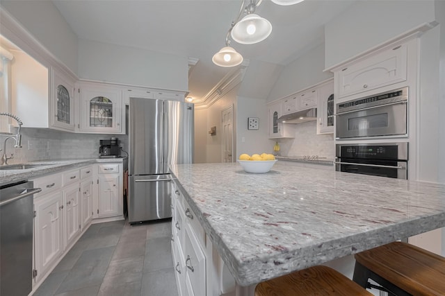 12438 Piping Rock Dr, Houston, TX 77077 - kitchen featuring stainless steel appliances, a sink, decorative backsplash, glass insert cabinets, and white cabinetry