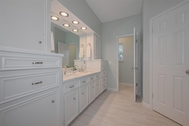 12438 Piping Rock Dr, Houston, TX 77077 - bathroom featuring recessed lighting, double vanity, and baseboards