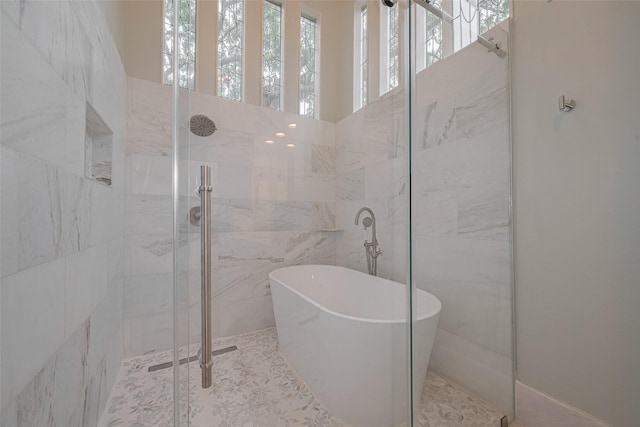 12438 Piping Rock Dr, Houston, TX 77077 - bathroom with a marble finish shower, a freestanding bath, and tile walls