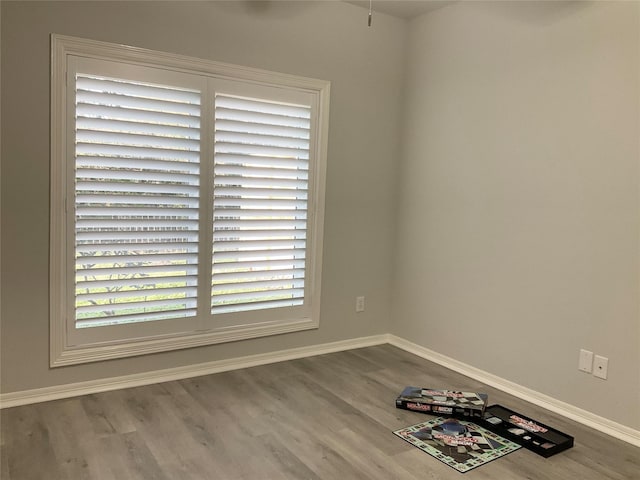 empty room with wood finished floors and baseboards