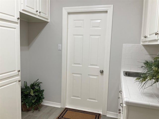 mudroom featuring baseboards and wood finished floors