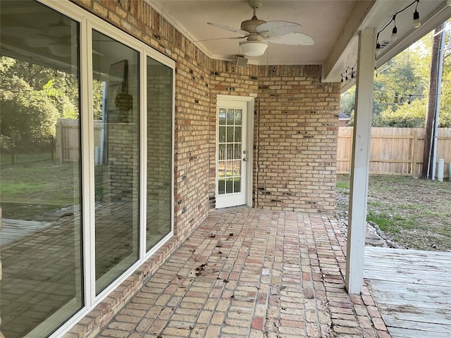 view of patio with ceiling fan and fence