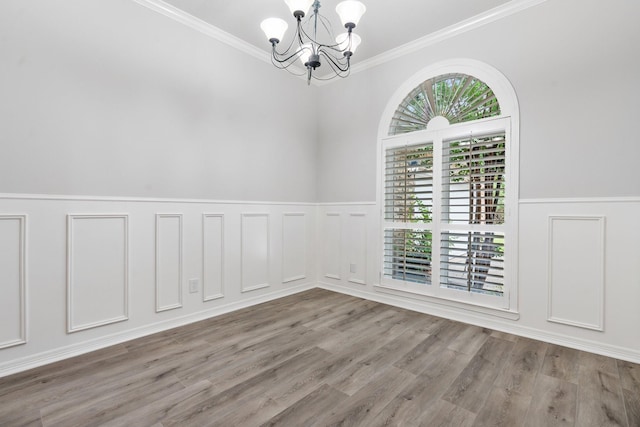 25818 Overlake Dr, Spring, TX 77380 - unfurnished room featuring a chandelier, wainscoting, ornamental molding, wood finished floors, and a decorative wall