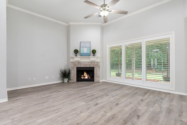 25818 Overlake Dr, Spring, TX 77380 - unfurnished living room with a tile fireplace, wood finished floors, ornamental molding, and a ceiling fan