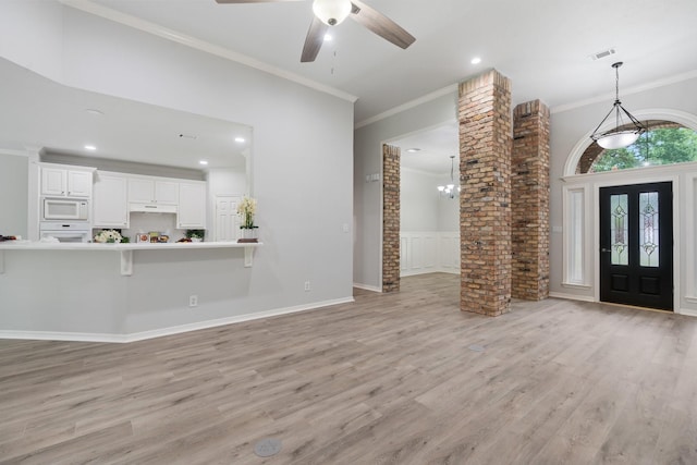 25818 Overlake Dr, Spring, TX 77380 - entryway featuring ornamental molding, light wood-style floors, a ceiling fan, recessed lighting, and a wainscoted wall
