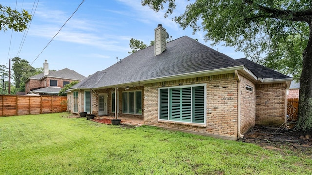25818 Overlake Dr, Spring, TX 77380 - back of property with a fenced backyard, roof with shingles, brick siding, and a chimney