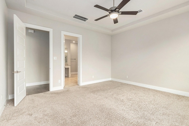 28622 Mountain Timber Ct, Fulshear, TX 77441 - unfurnished bedroom with carpet, a raised ceiling, baseboards, and ensuite bathroom